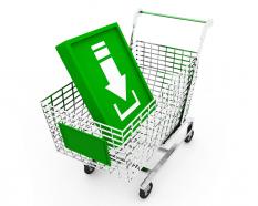 Shopping cart with green box and white arrow pointing downward stock photo