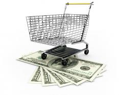 Shopping trolley on dollars to display money and marketing concept stock photo