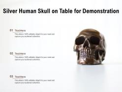Silver human skull on table for demonstration