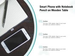 Smart phone with notebook pencil on wooden table