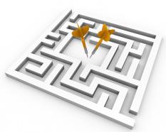 Square maze with two different yellow arrows showing target achievement stock photo