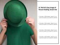 St patricks day image of person holding green hat