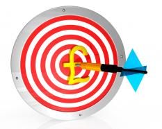 Target dart with pound symbol and arrow stock photo