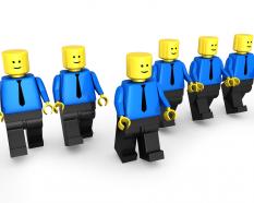 Team of lego men with leader standing ahead stock photo