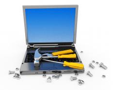 Technical service of laptop with hammer screwdriver nuts stock photo