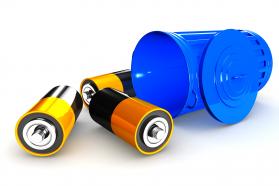 Three batteries with blue recycle bin stock photo