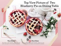 Top view picture of two blueberry pie on dining table