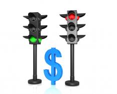 Traffic lights with red and green signals and dollar stock photo