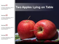 Two apples lying on table