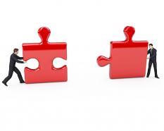 Two business men holding puzzle for solution building stock photo