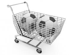 Two footballs in shopping cart for sales and marketing stock photo