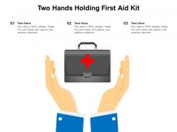Two hands holding first aid kit