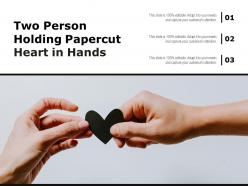 Two person holding papercut heart in hands