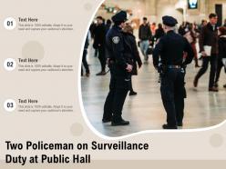 Two policeman on surveillance duty at public hall