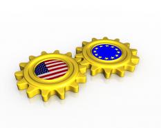 Union of us and european flags inside gears stock photo