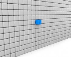 Wall made of white cubes with a blue cube as leader stock photo