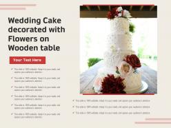 Wedding cake decorated with flowers on wooden table