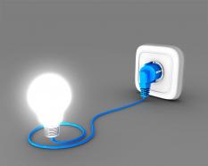 White glowing bulb with blue plug stock photo