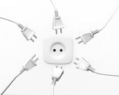 White plugs in circle with one socket in centre for problem solving stock photo