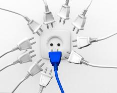 White plugs with one blue plug to show leadership stock photo