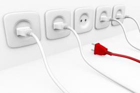 White plugs with sockets and one red plug for leadership stock photo