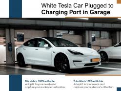 White tesla car plugged to charging port in garage