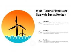 Wind turbine fitted near sea with sun at horizon