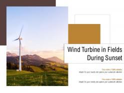 Wind turbine in fields during sunset