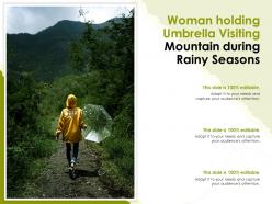 Woman holding umbrella visiting mountain during rainy seasons