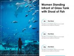 Women Standing Infront Of Glass Tank With Shoal Of Fish