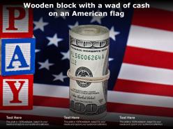 Wooden block with a wad of cash on an american flag