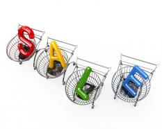 Word sale in four shopping carts on white background stock photo