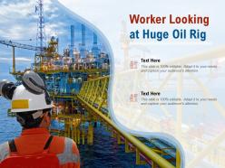 Worker looking at huge oil rig