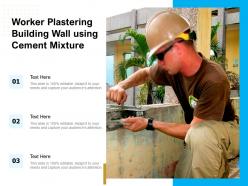 Worker plastering building wall using cement mixture