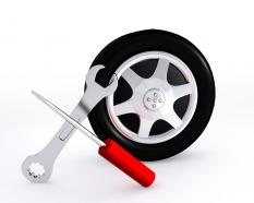Wrench and screwdriver with tire showing service stock photo