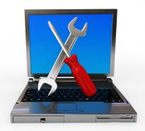 Wrench with screwdriver and laptop for service repair stock photo