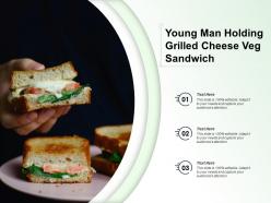 Young man holding grilled cheese veg sandwich