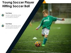 Young soccer player hitting soccer ball
