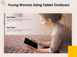 Young woman using tablet outdoors