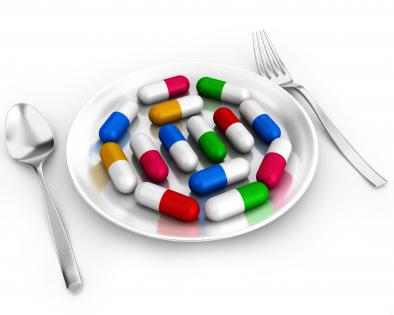 0914 capsules on plate with fork and spoon for healthcare stock photo