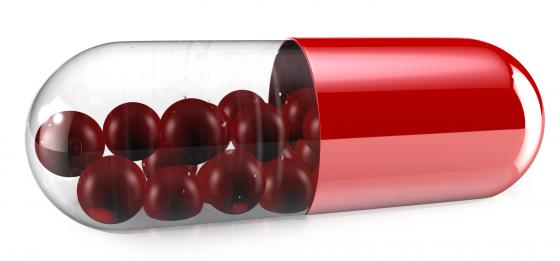 1114 red glass capsule on white background stock photo