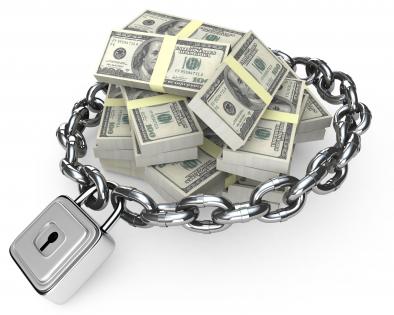 3d graphic of chain surrounding dollar bundles stock photo