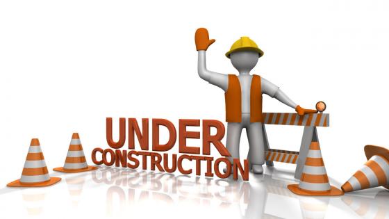 3d man showing under construction text with traffic cones stock photo