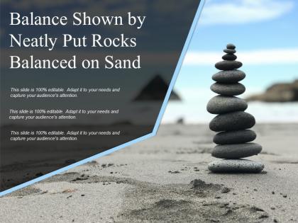 Balance shown by neatly put rocks balanced on sand
