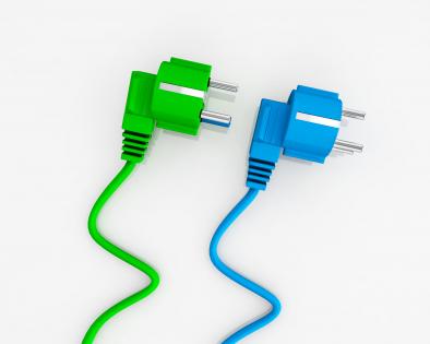 Blue and green electricity plugs on white background stock photo