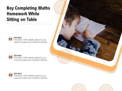 Boy completing maths homework while sitting on table