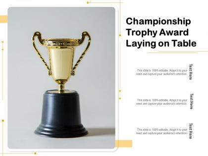 Championship trophy award laying on table