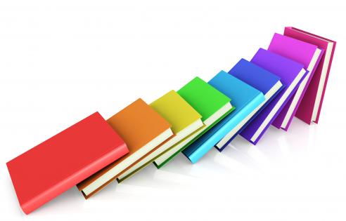 Colored books aligned like domino stock photo