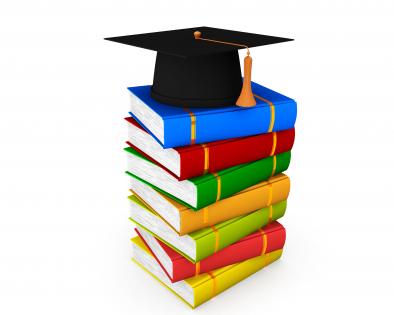 Colored books with graduation cap on top stock photo