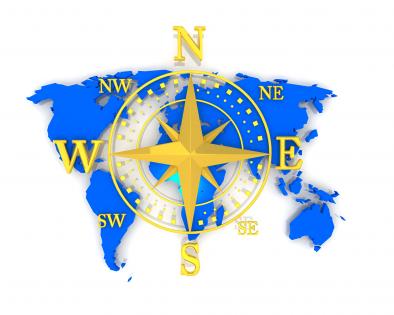Compass with directions on world map stock photo